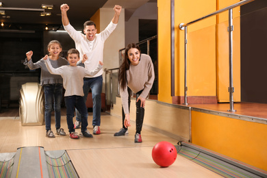 Happy family spending time together in bowling club