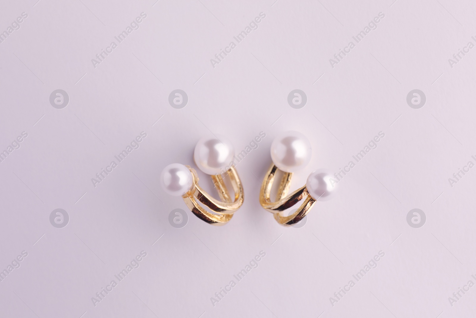 Photo of Elegant pearl earrings isolated on white, top view