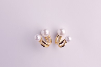 Photo of Elegant pearl earrings isolated on white, top view