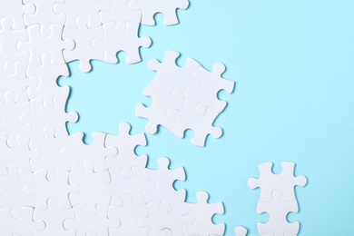 Photo of White puzzle on light blue background, flat lay