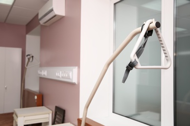 Triangle lifting pole in modern patient room