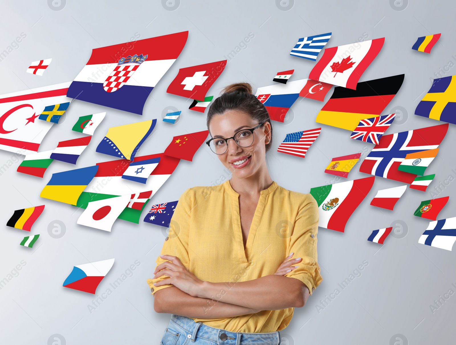 Image of Portrait of interpreter in eyeglasses and flags of different countries on light background