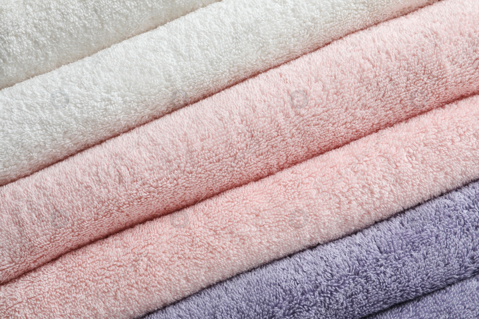 Photo of Stack of fresh soft towels as background