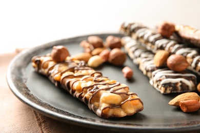 Photo of Homemade grain cereal bars with chocolate and nuts on plate