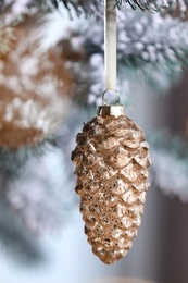 Photo of Christmas tree decorated with holiday bauble, closeup