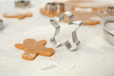 Making homemade Christmas cookies. Dough and gingerbread man cutter on table, closeup