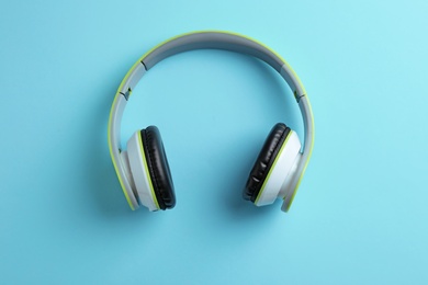 Photo of Wireless headphones on color background, top view