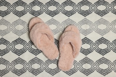 Photo of Slippers on soft bath mat, flat lay