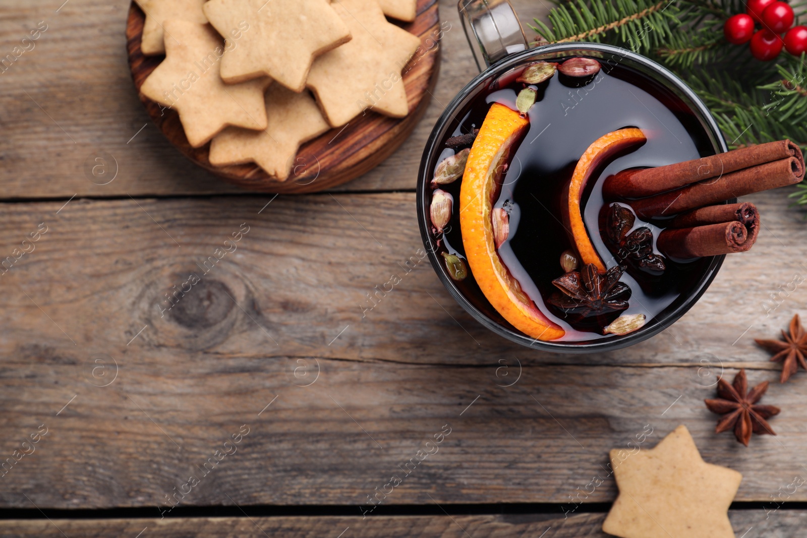 Photo of Flat lay composition with aromatic mulled wine on wooden table, space for text