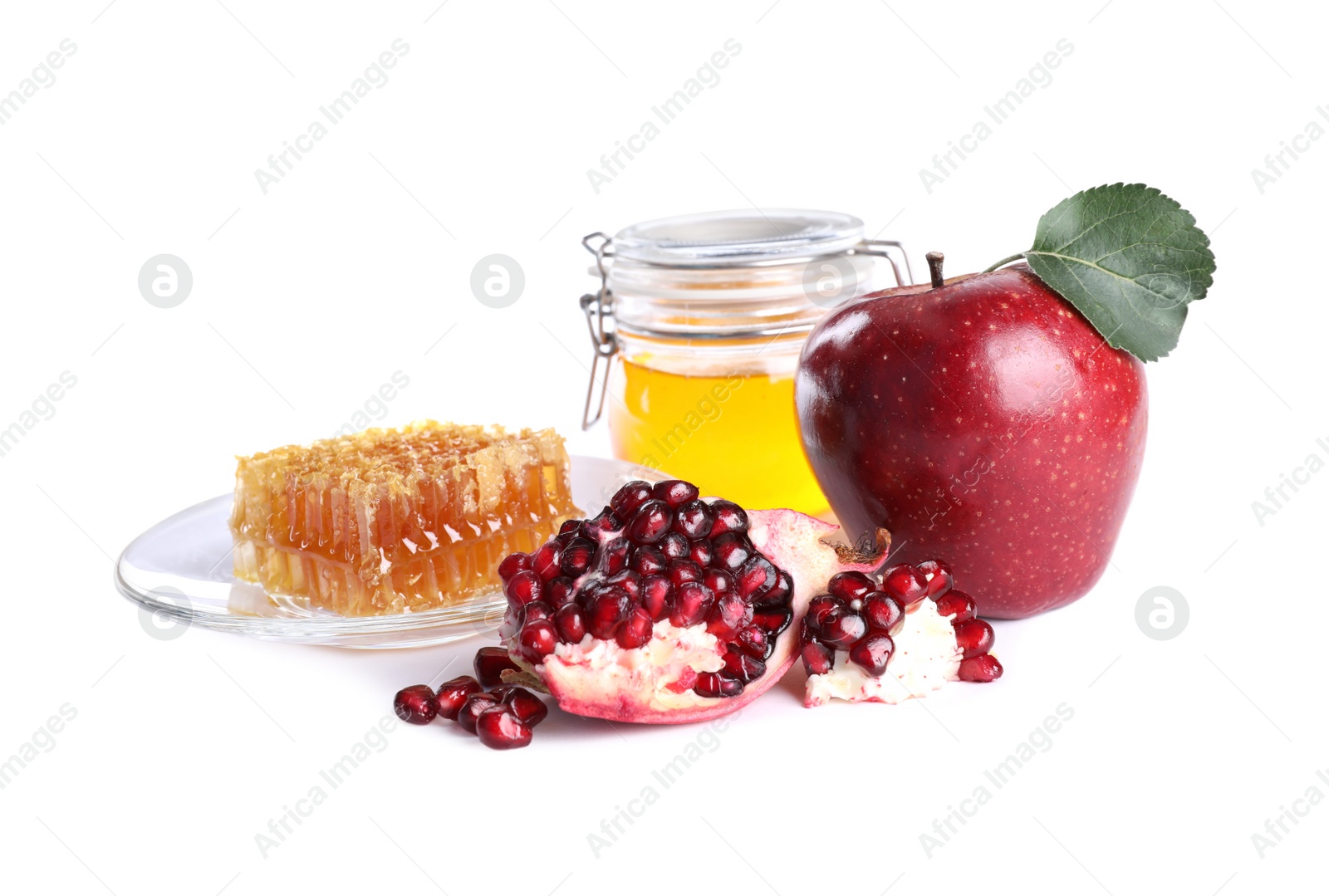 Photo of Honey, apple and pomegranate on white background. Rosh Hashanah holiday