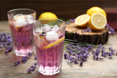 Photo of Fresh delicious lemonade with lavender on wooden table