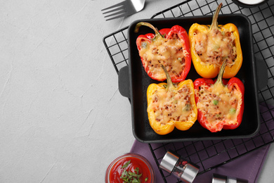 Photo of Flat lay composition with tasty stuffed bell peppers on grey table, space for text