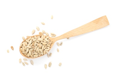 Peeled sunflower seeds in spoon on white background, top view