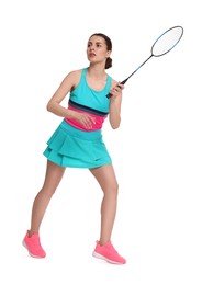 Young woman playing badminton with racket on white background