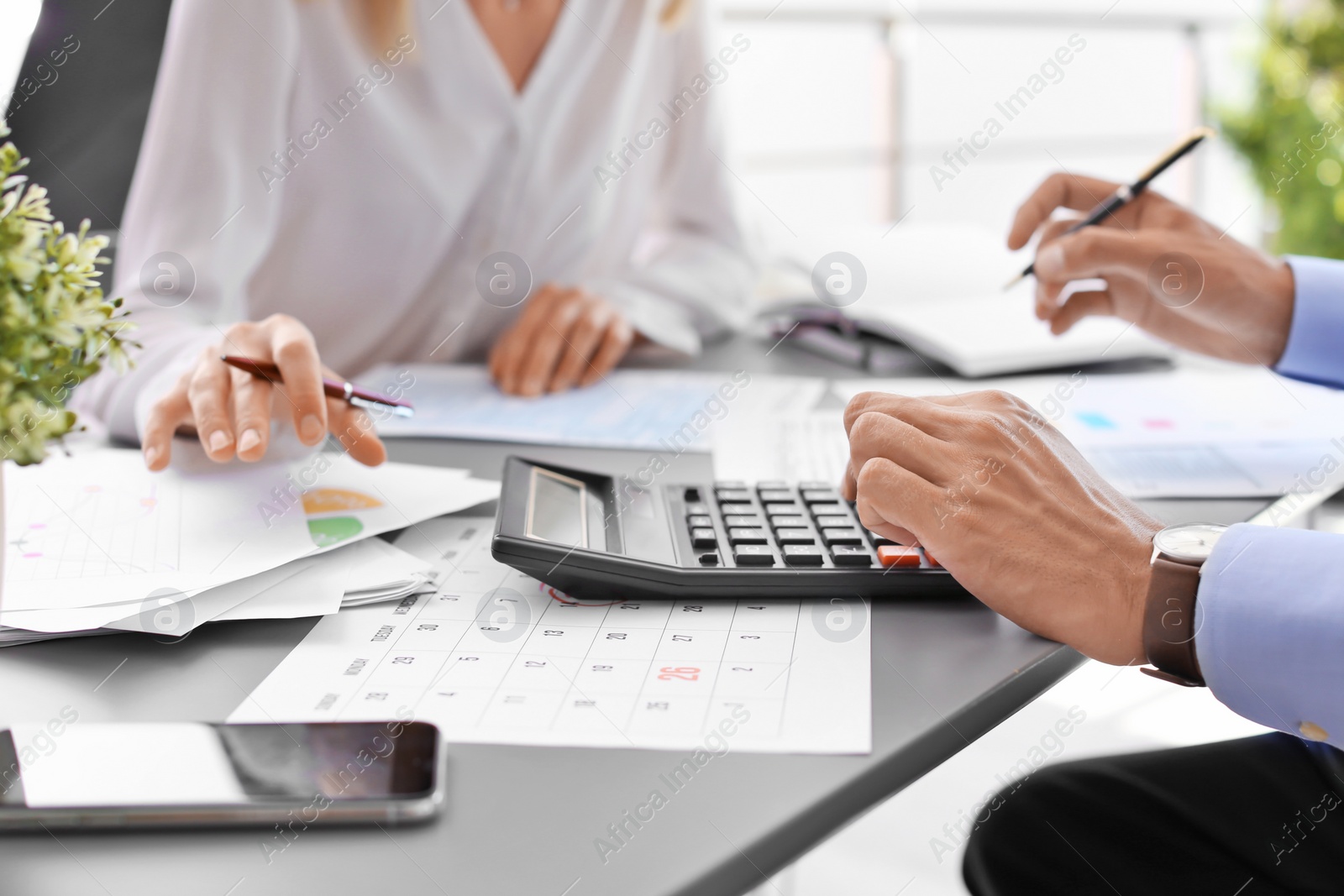 Photo of Tax accountants working with documents at table