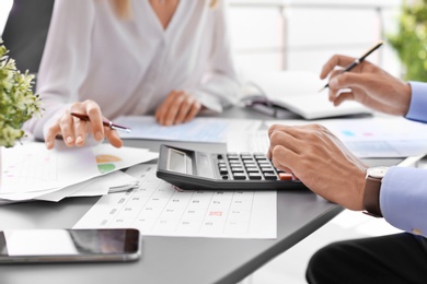 Photo of Tax accountants working with documents at table