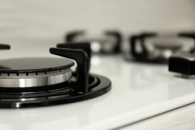 Modern built-in gas cooktop, closeup with space for text. Kitchen appliance