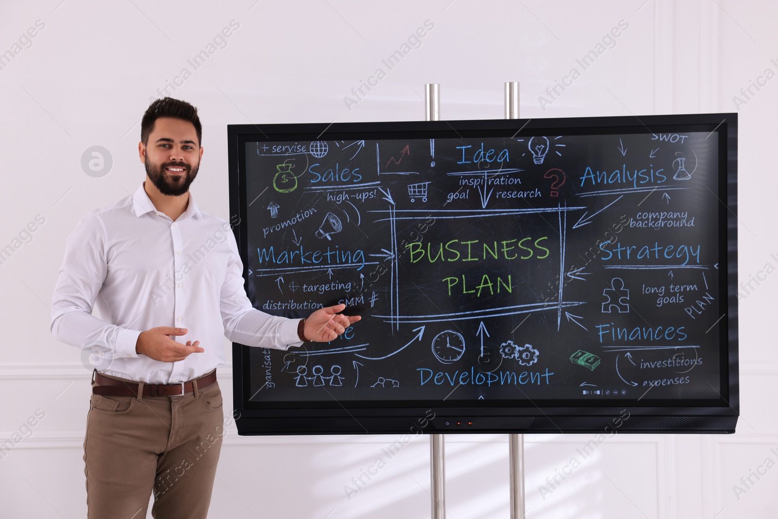 Photo of Business trainer using interactive board in meeting room