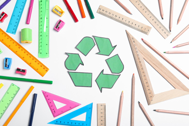 Photo of Recycling symbol, plastic and wooden stationery on white background, top view
