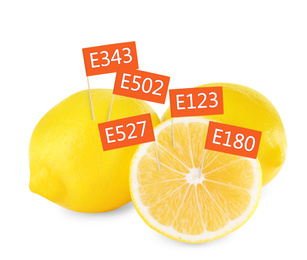 Image of Fresh lemons with E numbers on white background. Harmful food additives 