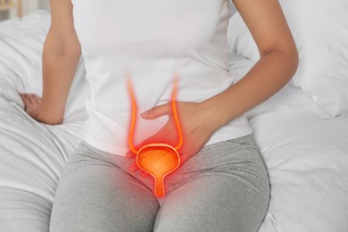 Woman suffering from cystitis on bed at home, closeup. Illustration of urinary system