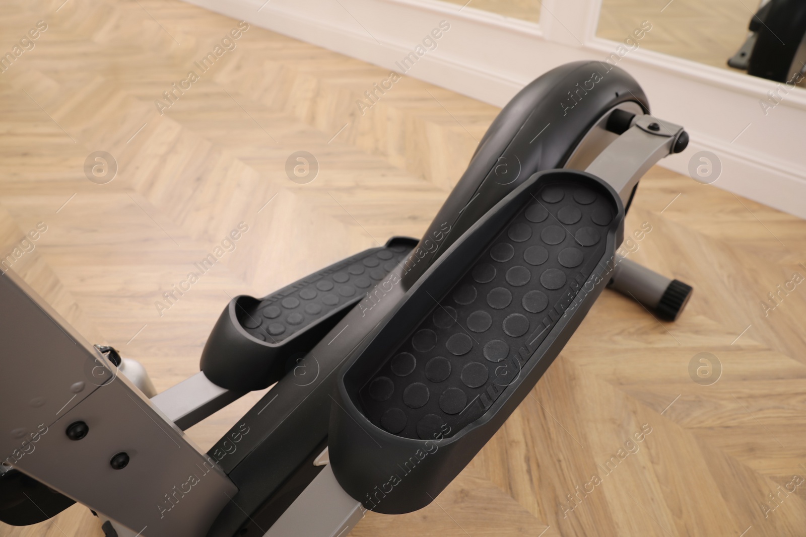 Photo of Modern elliptical machine cross trainer on floor indoors