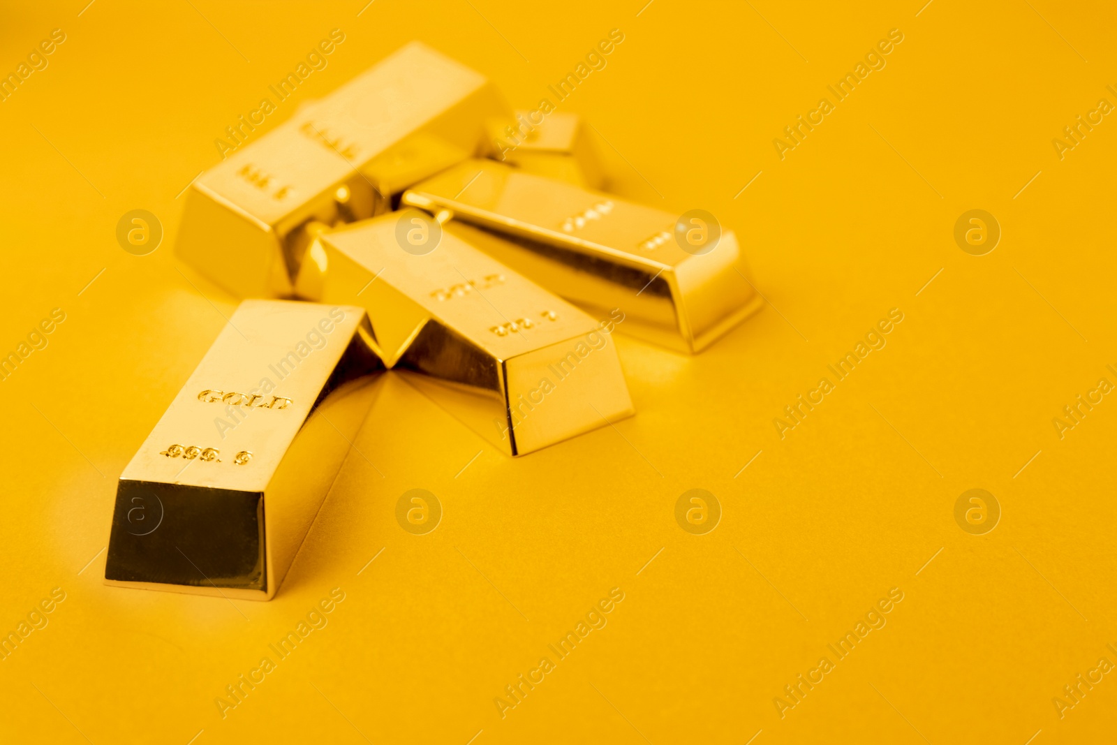 Photo of Precious shiny gold bars on color background. Space for text