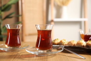 Photo of Traditional Turkish tea in glasses on wooden table