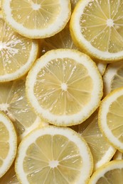 Slices of fresh lemons as background, top view