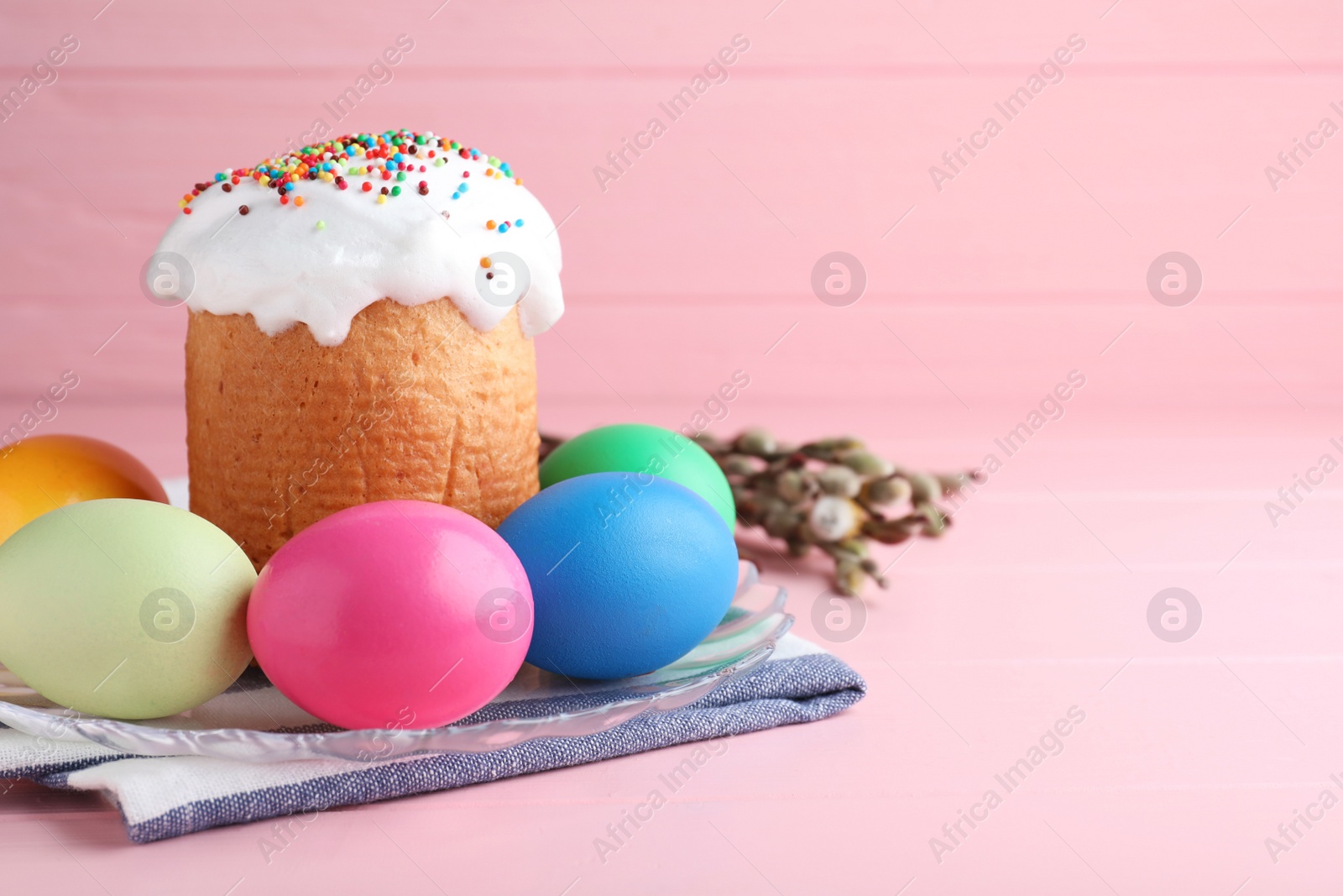 Photo of Traditional Easter cake, colorful eggs and willow branches on pink background. Space for text