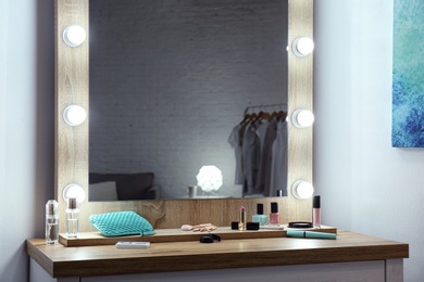 Photo of Makeup mirror on table near white wall in dressing room