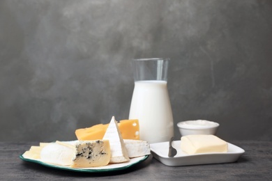 Photo of Different dairy products on table against grey background