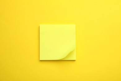 Photo of Paper note on yellow background, top view