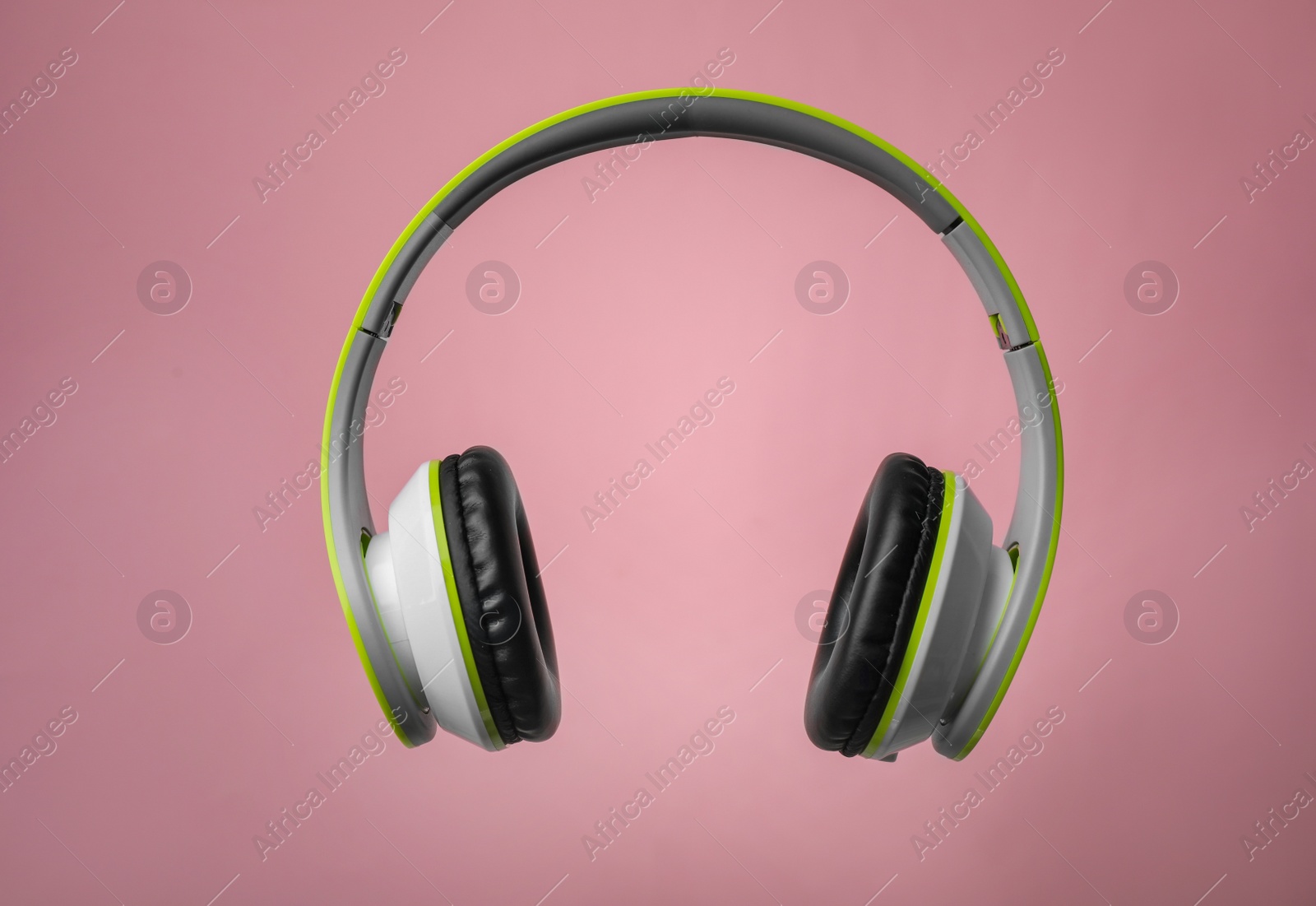 Photo of Wireless headphones with earmuffs on color background