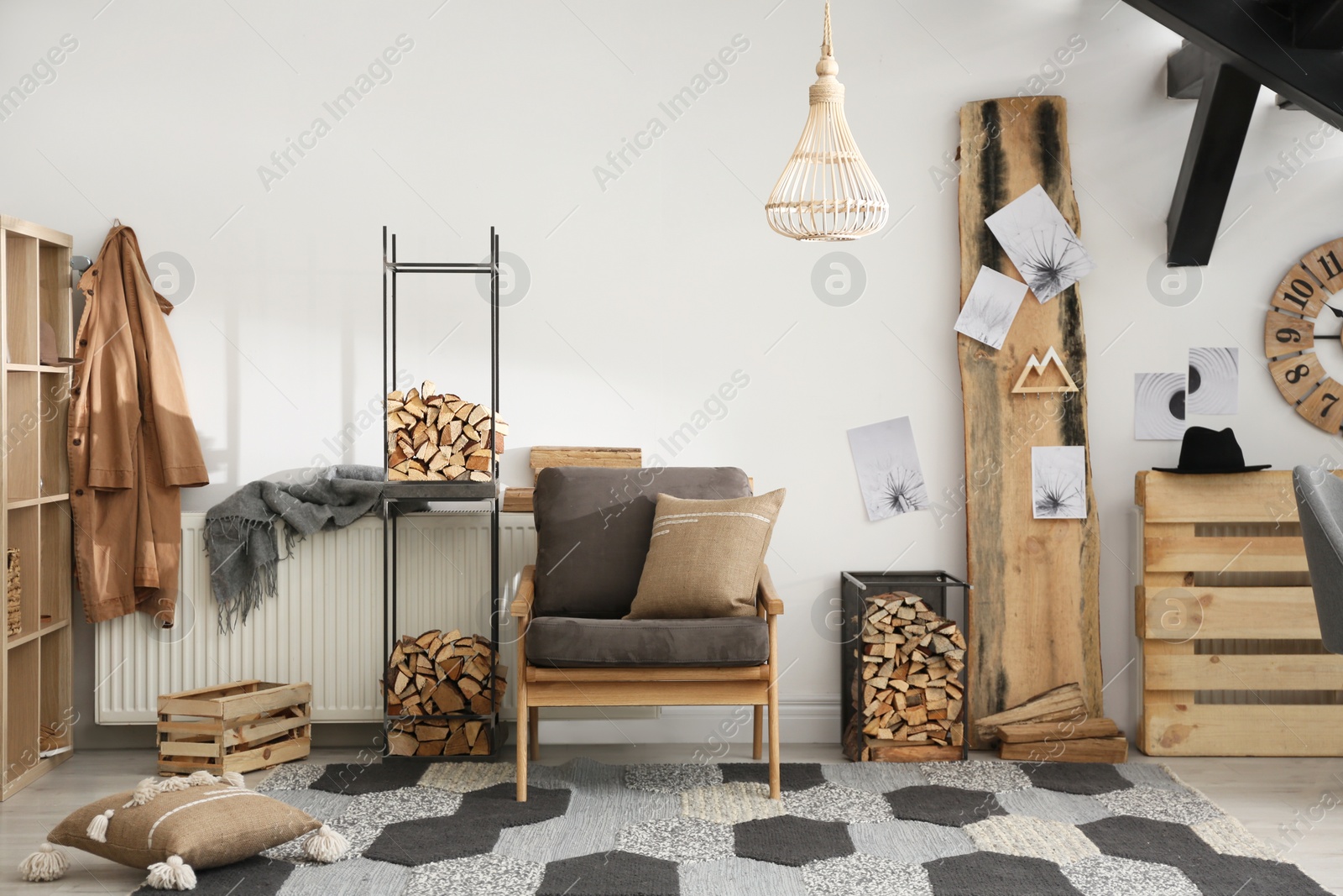 Photo of Stylish room interior with firewood as decorative element