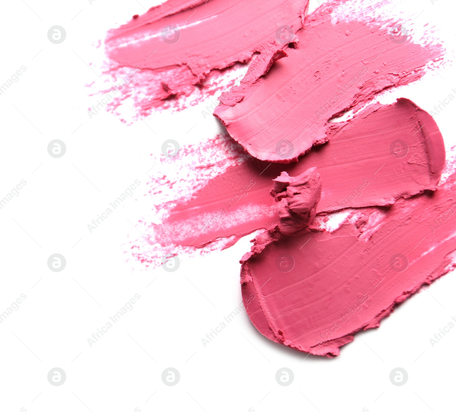 Photo of Smears of bright lipstick on white background, top view