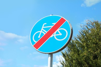 Traffic sign End Of Cycleway against blue sky, low angle view