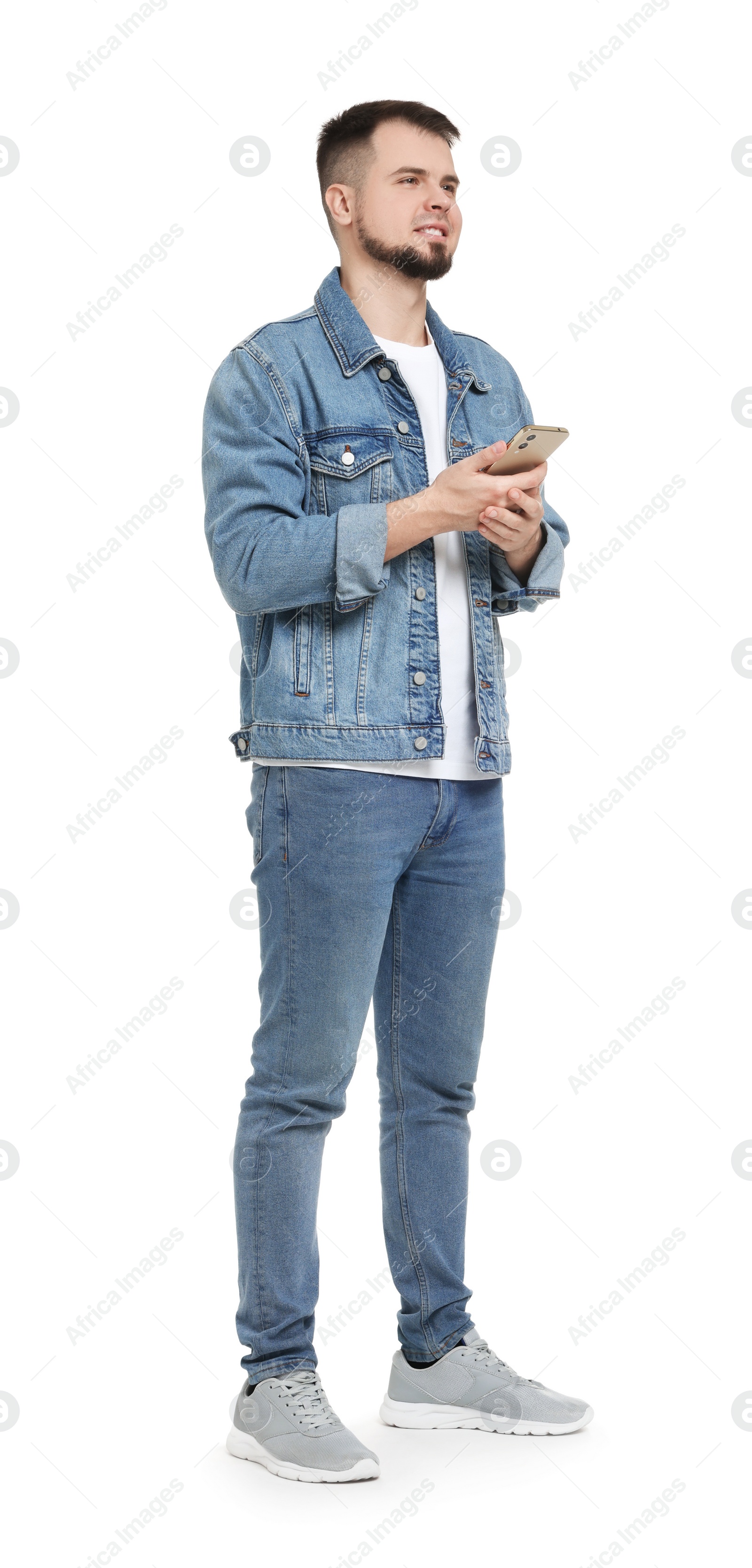 Photo of Man in denim clothes using mobile phone on white background