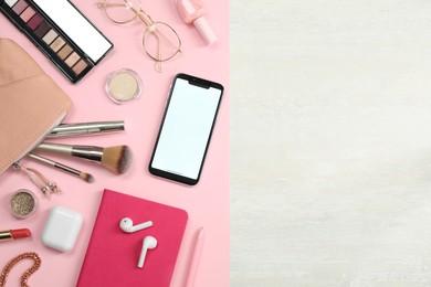 Flat lay composition with smartphone and makeup accessories on white table, space for text