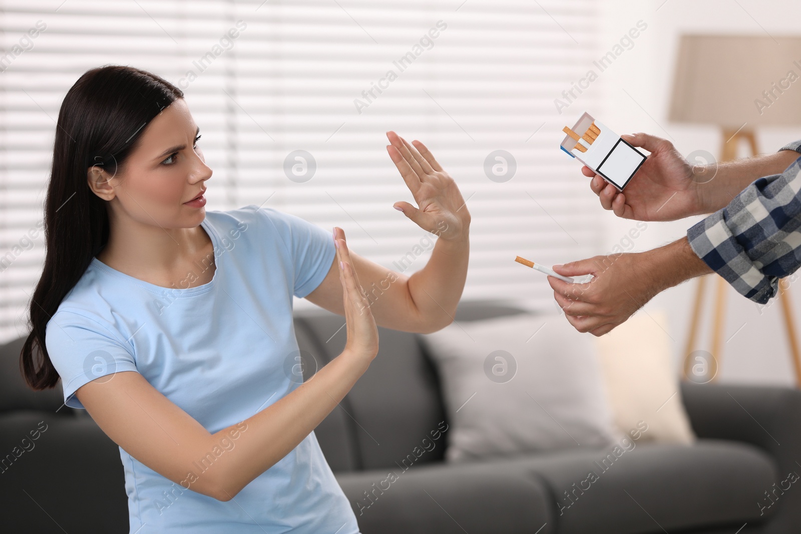 Photo of Stop smoking concept. Woman refusing cigarettes indoors