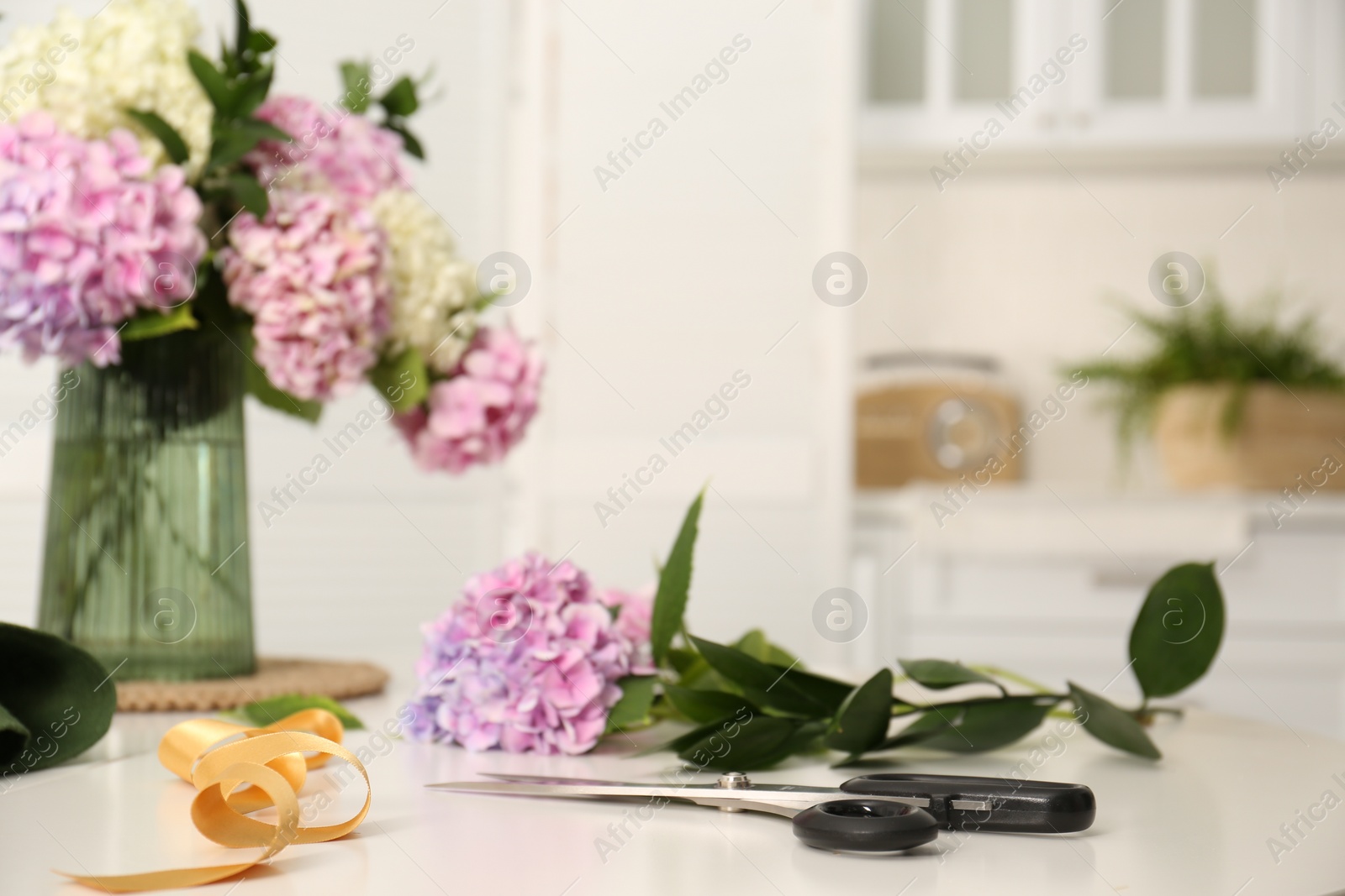 Photo of Bouquet of beautiful hydrangea flowers on white table indoors. Interior design