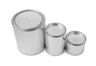 Photo of New metal paint cans on white background