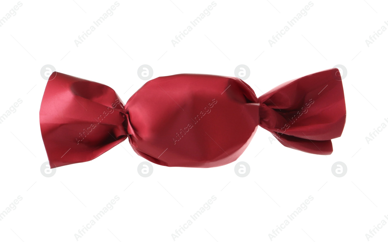 Photo of Delicious candy in red wrapper isolated on white