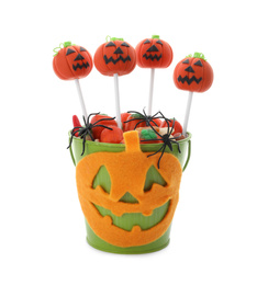 Photo of Delicious jack-o-lantern cake pops on white background. Halloween season