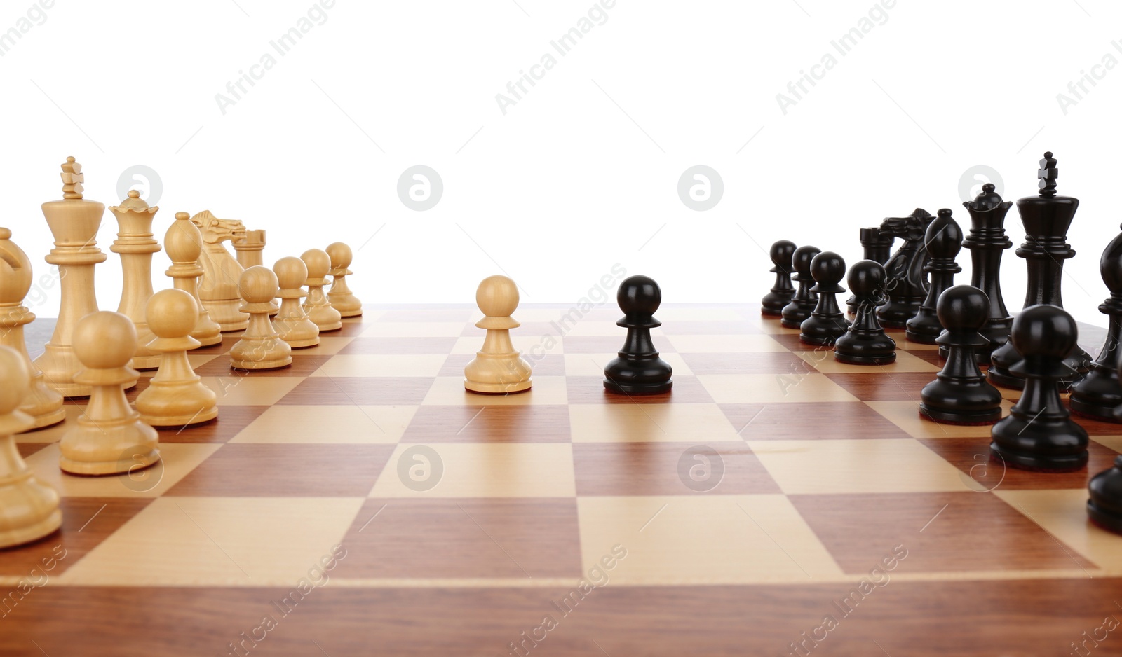 Photo of Chess pieces on wooden board against white background