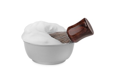 Photo of Bowl with shaving brush and foam on white background