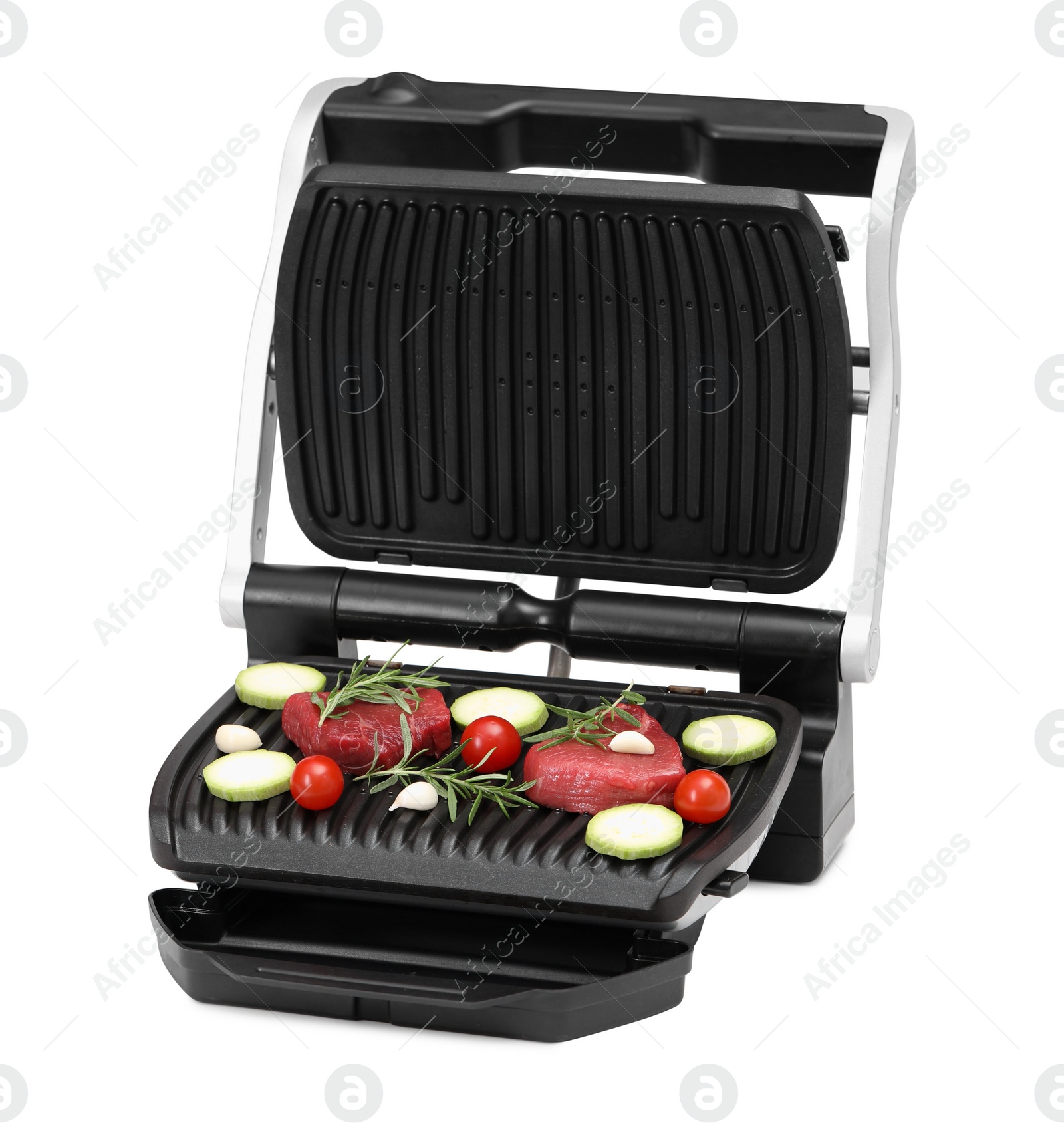 Photo of Electric grill with raw meat, rosemary and vegetables isolated on white