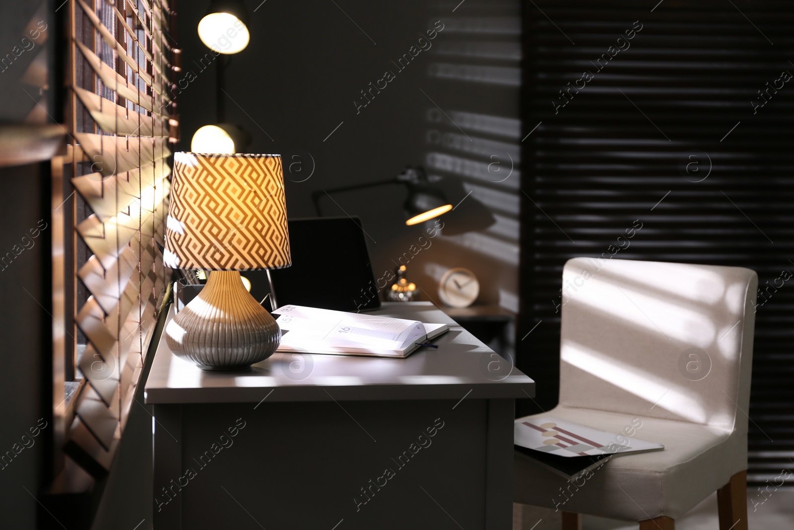 Photo of Stylish room interior with comfortable workplace near window