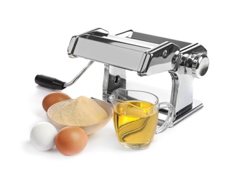 Photo of New pasta machine and products on white background