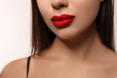 Photo of Woman with red lipstick on light background, closeup